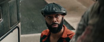 Movie still from “Alice” (2022), directed by Krystin Ver Linden – A man with a beard wearing a black hat; Close Up shot, Over the shoulder angle