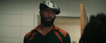 Movie still from “Alice” (2022), directed by Krystin Ver Linden – A man with a beard wearing a hat and jacket; Close Up shot, Low angle