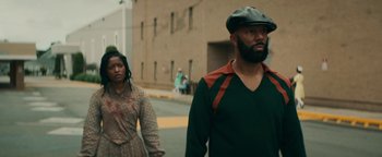 Movie still from “Alice” (2022), directed by Krystin Ver Linden – A man and a woman walking down a street; Medium shot, Over the shoulder angle