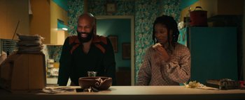 Movie still from “Alice” (2022), directed by Krystin Ver Linden – A man and a woman sitting at a table; Medium shot, High angle