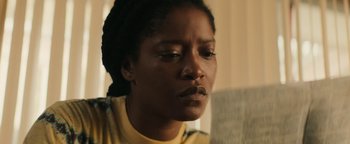 Movie still from “Alice” (2022), directed by Krystin Ver Linden – A person looking down at something; Close Up shot, Low angle