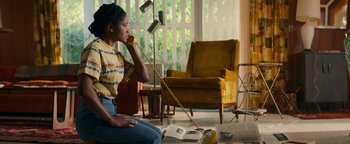 Movie still from “Alice” (2022), directed by Krystin Ver Linden – A woman sitting on the floor talking on a phone; Medium shot, High angle