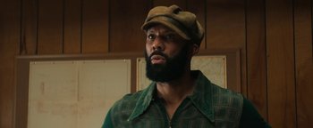 Movie still from “Alice” (2022), directed by Krystin Ver Linden – A man with a beard wearing a hat and a plaid shirt; Close Up shot, Low angle