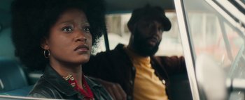 Movie still from “Alice” (2022), directed by Krystin Ver Linden – A man and a woman sitting in the back seat of a car; Close Up shot, Over the shoulder angle