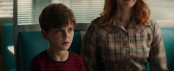 Movie still from “Alice” (2022), directed by Krystin Ver Linden – A boy and a woman sitting next to each other on a bus; Close Up shot, Over the shoulder angle