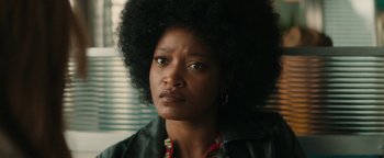 Movie still from “Alice” (2022), directed by Krystin Ver Linden – A person wearing a black jacket; Close Up shot, Over the shoulder angle