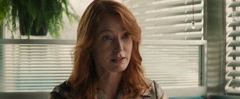 Movie still from “Alice” (2022), directed by Krystin Ver Linden – A person with long red hair; Close Up shot, Over the shoulder angle
