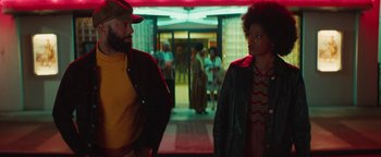 Movie still from “Alice” (2022), directed by Krystin Ver Linden – A man and a woman are walking in a hallway; Medium shot, Over the shoulder angle