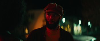 Movie still from “Alice” (2022), directed by Krystin Ver Linden – A man with a beard wearing a hat and a jacket; Close Up shot, Low angle