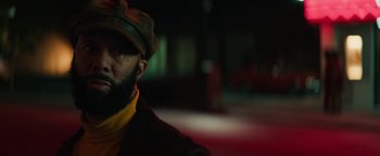 Movie still from “Alice” (2022), directed by Krystin Ver Linden – A man with a beard wearing a hat and a jacket; Close Up shot, Low angle