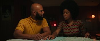 Movie still from “Alice” (2022), directed by Krystin Ver Linden – A man and a woman sitting at a dinner table; Medium shot, Over the shoulder angle