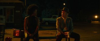 Movie still from “Alice” (2022), directed by Krystin Ver Linden – A man and a woman sitting on a bench at night; Medium shot, Over the shoulder angle