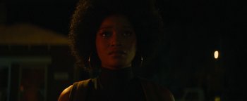 Movie still from “Alice” (2022), directed by Krystin Ver Linden – A woman with a large afro in the dark; Close Up shot, Low angle