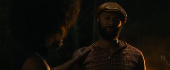 Movie still from “Alice” (2022), directed by Krystin Ver Linden – A man with a beard wearing a hat and a jacket; Close Up shot, Over the shoulder angle