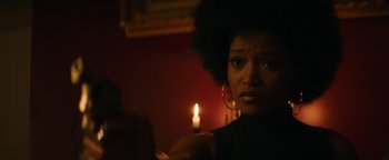 Movie still from “Alice” (2022), directed by Krystin Ver Linden – A woman with a candle in the dark; Close Up shot, Low angle