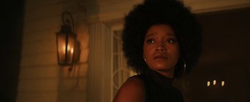 Movie still from “Alice” (2022), directed by Krystin Ver Linden – A person wearing a black shirt; Close Up shot, Low angle