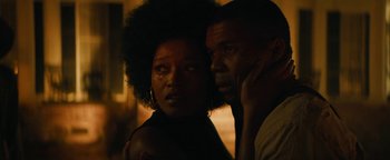 Movie still from “Alice” (2022), directed by Krystin Ver Linden – A man and a woman standing next to each other in the dark; Close Up shot, Over the shoulder angle