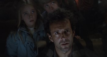 Movie still from “Aliens” (1986), directed by James Cameron – A man and two children in a dark room; Close Up shot, Low angle