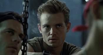 Movie still from “Aliens” (1986), directed by James Cameron – A person wearing a necklace; Close Up shot, Low angle