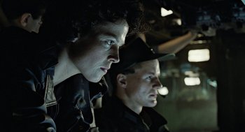 Movie still from “Aliens” (1986), directed by James Cameron – Two men in uniform looking into the distance; Close Up shot, Low angle