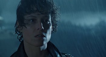 Movie still from “Aliens” (1986), directed by James Cameron – A person in the rain; Close Up shot, Low angle