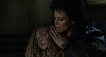 Movie still from “Aliens” (1986), directed by James Cameron – A woman and a child are looking at each other; Close Up shot, Low angle