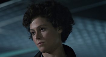 Movie still from “Aliens” (1986), directed by James Cameron – A person wearing a black jacket; Close Up shot, Over the shoulder angle