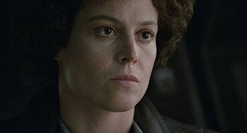 Movie still from “Aliens” (1986), directed by James Cameron – A person with curly brown hair; Close Up shot, Low angle