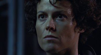 Movie still from “Aliens” (1986), directed by James Cameron – A woman's face with dark makeup; Close Up shot, Low angle