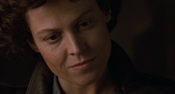 Movie still from “Aliens” (1986), directed by James Cameron – A woman's face in the dark; Close Up shot, Low angle