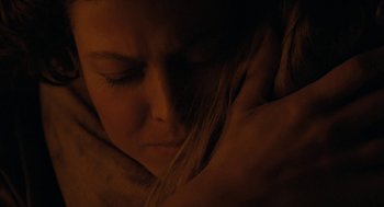 Movie still from “Aliens” (1986), directed by James Cameron – A woman's face in the dark; Close Up shot, Over the shoulder angle