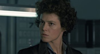 Movie still from “Aliens” (1986), directed by James Cameron – A person with curly hair; Close Up shot, Low angle