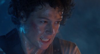 Movie still from “Aliens” (1986), directed by James Cameron – A person with blue paint on their face; Close Up shot, Low angle