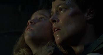 Movie still from “Aliens” (1986), directed by James Cameron – A man and a woman looking into the distance; Close Up shot, Low angle