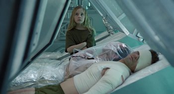 Movie still from “Aliens” (1986), directed by James Cameron – A woman and a man laying in a hospital bed; Medium shot, Over the shoulder angle