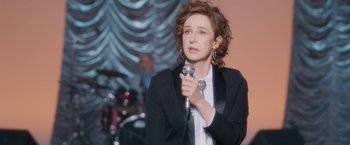 A woman holding a microphone in her hand