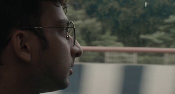 Movie still from “All That Breathes” (2022), directed by Shaunak Sen – A person wearing glasses; Extreme Close Up shot, Low angle