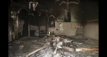 Movie still from “All That Breathes” (2022), directed by Shaunak Sen – A room that has been burned down and is very dirty; Extreme Wide shot, High angle