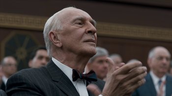 Movie still from “All the Way” (2016), directed by Jay Roach – An older man claps his hands in front of a group of people; Close Up shot, Low angle