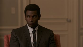 Movie still from “All the Way” (2016), directed by Jay Roach – A man wearing a suit and tie sitting in a chair; Close Up shot, Over the shoulder angle