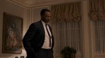Movie still from “All the Way” (2016), directed by Jay Roach – A man wearing a suit and tie standing in a room; Medium shot, Low angle