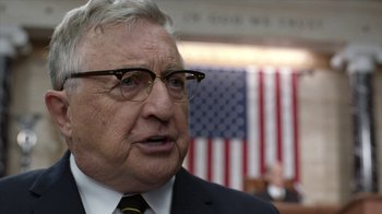 Movie still from “All the Way” (2016), directed by Jay Roach – An older man wearing glasses and a suit and tie; Close Up shot, Over the shoulder angle