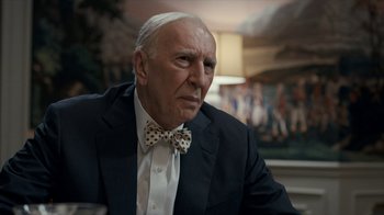 Movie still from “All the Way” (2016), directed by Jay Roach – An older man wearing a suit and a bow tie; Close Up shot, Over the shoulder angle