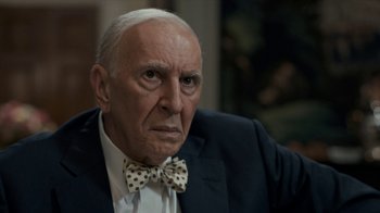Movie still from “All the Way” (2016), directed by Jay Roach – An older man wearing a suit and a bow tie; Close Up shot, Over the shoulder angle