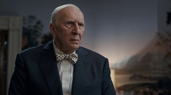 Movie still from “All the Way” (2016), directed by Jay Roach – An older man wearing a suit and a bow tie; Close Up shot, Over the shoulder angle