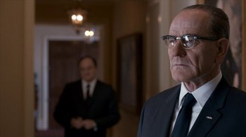 Movie still from “All the Way” (2016), directed by Jay Roach – A man in a suit and tie standing in front of another man; Close Up shot, Low angle