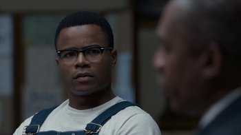 Movie still from “All the Way” (2016), directed by Jay Roach – A person wearing glasses and a white shirt; Close Up shot, Over the shoulder angle