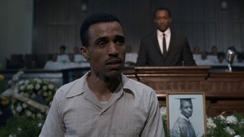 Movie still from “All the Way” (2016), directed by Jay Roach – A man standing in front of a man in a suit and tie; Close Up shot, Over the shoulder angle