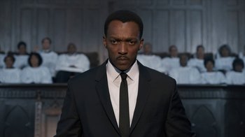 Movie still from “All the Way” (2016), directed by Jay Roach – A man in a suit and tie in front of a group of people; Close Up shot, Low angle