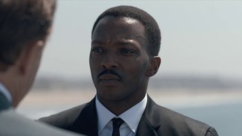 Movie still from “All the Way” (2016), directed by Jay Roach – A man in a suit and tie looking to his left; Close Up shot, Over the shoulder angle